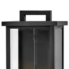 an outdoor wall light with a black frame and white glass panels on the front side