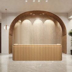 an empty lobby with a wooden wall and white marble flooring, along with two planters on either side