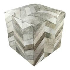 a small stool made out of grey and white squares on top of eachother