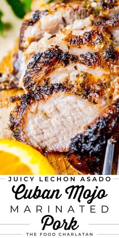 grilled pork on a cutting board with lemons and parsley in the background