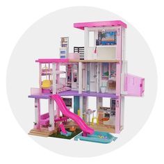 a pink doll house with a slide down to the second floor and lots of furniture