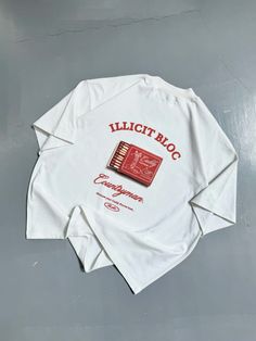 a white t - shirt with red writing on it that says illittroc