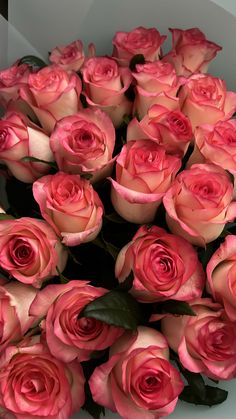 a bouquet of pink roses in a white box