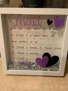 a white frame with purple and black hearts in it that reads, friend gives you hope when life is low