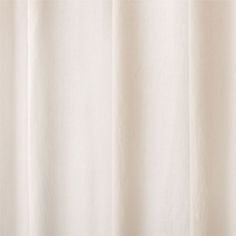 a white curtain hanging on the side of a window