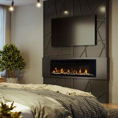 a bedroom with a bed, fireplace and television on the wall in front of it