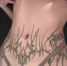 a close up of a person with tattoos on their stomach