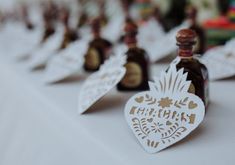 small bottles are lined up on a table