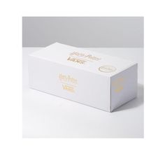 a white box with gold foil on the top and bottom that says happy new years