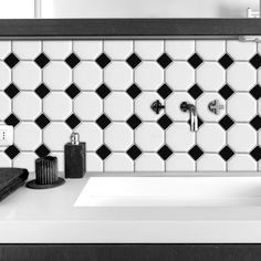 a black and white photo of a bathroom sink