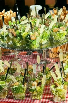 a table topped with lots of salads and fries