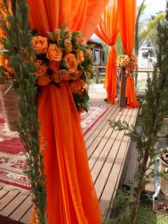 an orange wedding set up with flowers and greenery