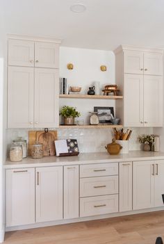 the kitchen is clean and ready for us to use it's white cabinetry