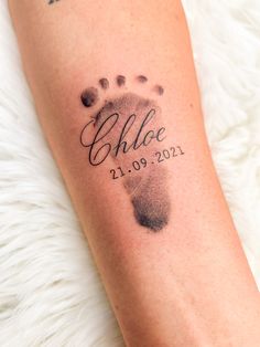 a close up of a person's foot with a tattoo that reads, birth date