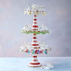 there is a three tiered cake stand with many decorations on the top and bottom