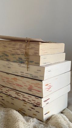 a stack of books sitting on top of a white blanket