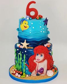 there is a birthday cake with an image of the little mermaid on it