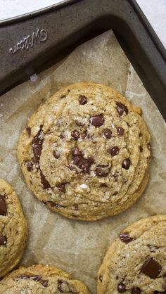 chocolate chip cookies on parchment paper in a baking pan, ready to go into the oven