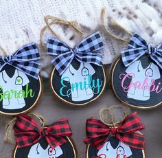 four personalized christmas ornament ornaments with plaid bows on them and the name