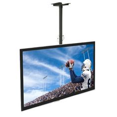 a television hanging from the ceiling with a football player on it's arm and hands up in the air