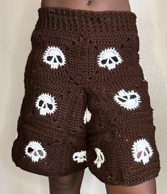 there is a crocheted shorts with skulls on the side and holes in the bottom