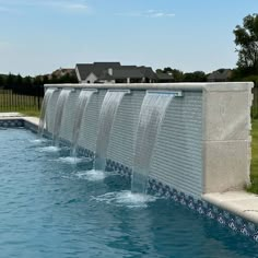 a large water feature in the middle of a swimming pool