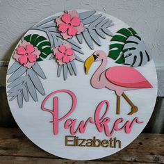 a sign that says parker elizabeth with a pink flamingo and tropical leaves on it