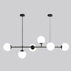 a black and white chandelier with five lights hanging from it's sides