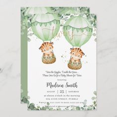 a green and white baby shower with two hot air balloons