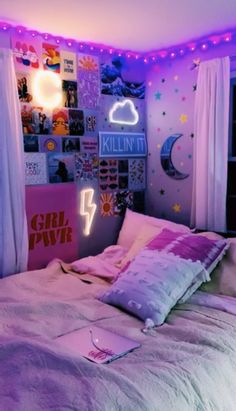 a bedroom with pink and purple lights on the ceiling