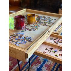 a wooden table with puzzle pieces on it