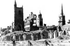 an old black and white photo of a city with tall buildings on the top of it