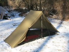 a tent is pitched up in the snow