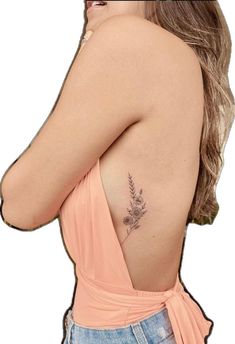 a woman with a flower tattoo on her back