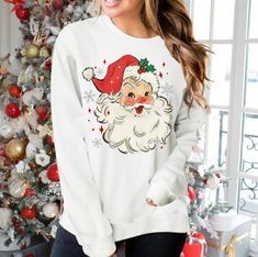 "Retro Santa Shirt, Christmas Crewneck, Vintage Santa Claus, Retro Christmas Sweatshirt, Santa face shirt  Sizing Note  Unisex sweatshirts run a little larger than typical women's shirts and slightly smaller than typical men's shirts. Depending on fit preference and body type, these unisex t-sweatshirts may be true to size or larger than expected for women. SIZES + Shirt Measurements (Width/Length) ♦Small - 18\" / 28\" ♦Med - 20\" / 29\" ♦Large - 22\" / 30\" ♦XL - 24\" / 31\" ♦XXL - 28\" / 32\" Santa Face Christmas Shirts, Santa Face Shirts Vinyl, Santa Face Christmas Shirt, Santa Sweatshirt, Santa Shirts, Vintage Santa Claus, Santa Face, Holiday Sweater, Christmas Pajamas