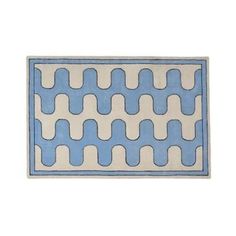 a blue and white rug with wavy lines on the bottom, in front of a white background