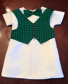 a green and white shirt with a bow tie