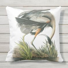 a bird with its wings spread out sitting on the ground throw pillow by artist unknown