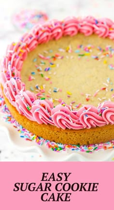 an easy sugar cookie cake with pink frosting and sprinkles on top