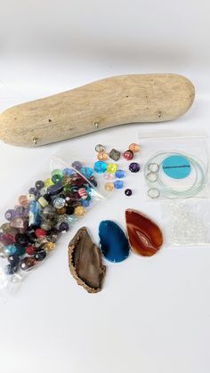 various beads and other items are laid out on a white surface, including a long bone