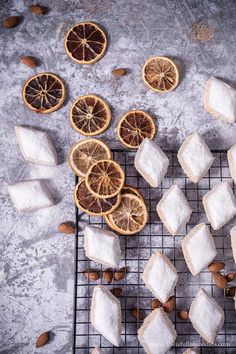 oranges, almonds and sugar cubes on a cooling rack with squares cut in half