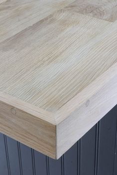 a close up view of the top of a wooden table with black metal legs and wood grains