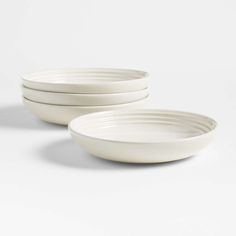 three white bowls sitting on top of each other