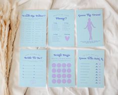 four blue and pink wedding cards on top of a white bed with dried grass next to them