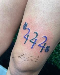 a person with a tattoo on their leg that reads 424 and has two butterflies