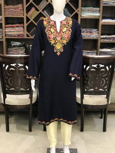 A stunningly marvellous Pheran. This Pheran features intricate Kashmir Aari embroidery on neckline and sleeves.- - - - - - - - - - - - - - - - - - - - Product Details- Condition: Brand New (made to order)- Style: Pheran Tunic- Fabric: Wool- Colour: Navy Blue- Embroidery: Aari Work- Embroidery Colour: Multi-Colour- Standard Length: 40" - Care Instructions: Dry Clean Only.**If you want the Tunic to be shorter or longer, just send us a message, and we will tailor it accordingly.Sizing- Please selec Semi-stitched Multicolor Embroidery Dress With Long Sleeves, Traditional Embroidered V-neck Dress For Eid, Semi-stitched Long Sleeve Dress With Multicolor Embroidery, Traditional Semi-stitched V-neck Dress, Elegant Multicolor Kurta With Floral Embroidery, Traditional Festive Embroidered Tunic Dress, Traditional Multicolor V-neck Tunic, Traditional V-neck Dress With Intricate Embroidery, Traditional Tunic Dress With Zari Work