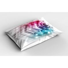 a pillow that is sitting on top of a white surface with colorful lights in the background