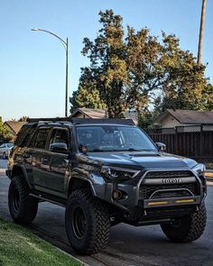 a black truck parked on the side of a road