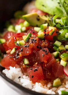 a bowl filled with rice and vegetables on top of a table