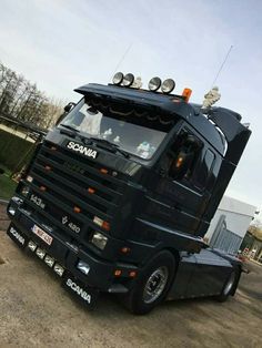 a large black truck parked in a parking lot